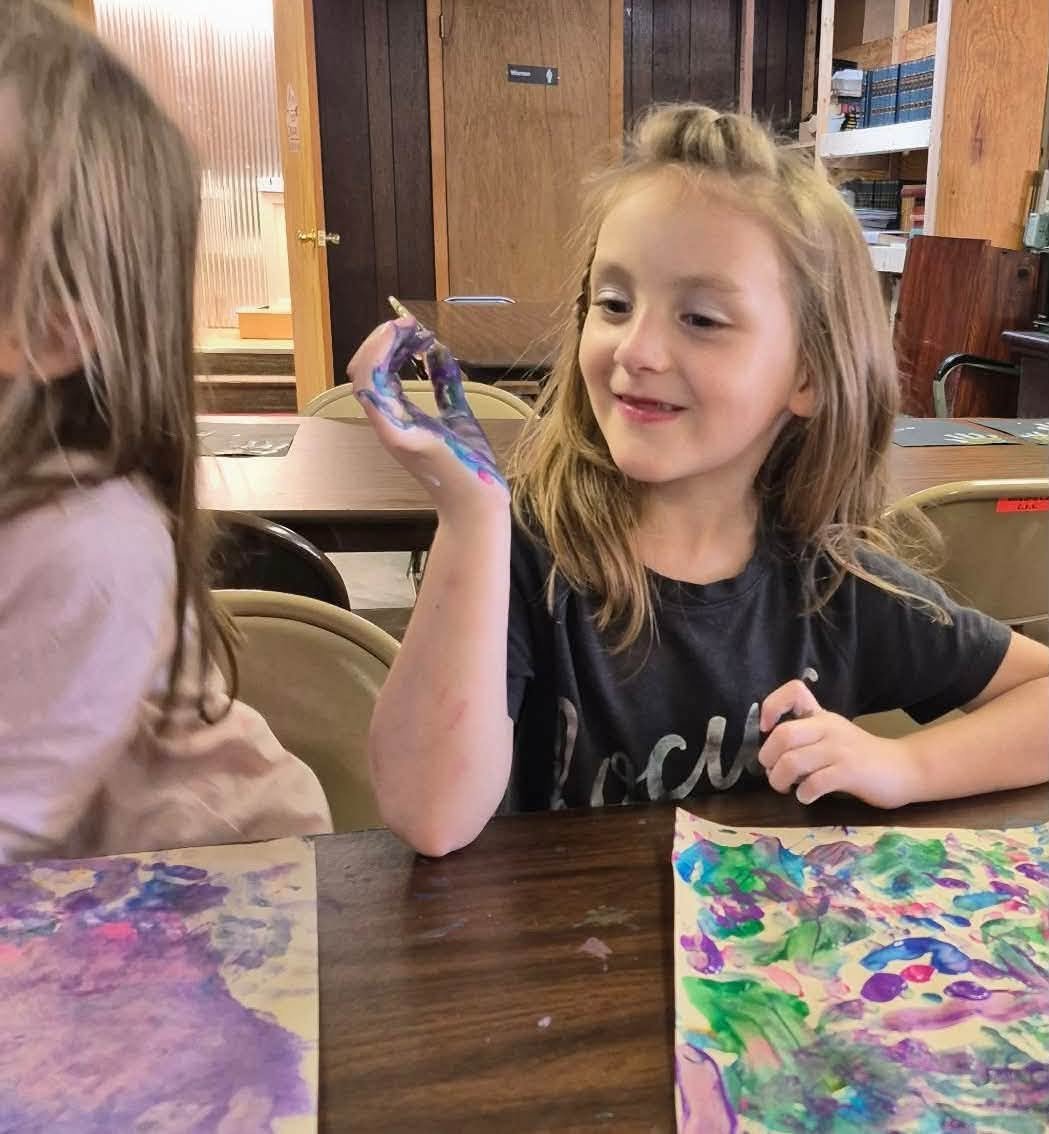 A student with her painted artwork